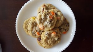 cookies with chocolate chips, pretzels and Reese's Pieces on a white plate